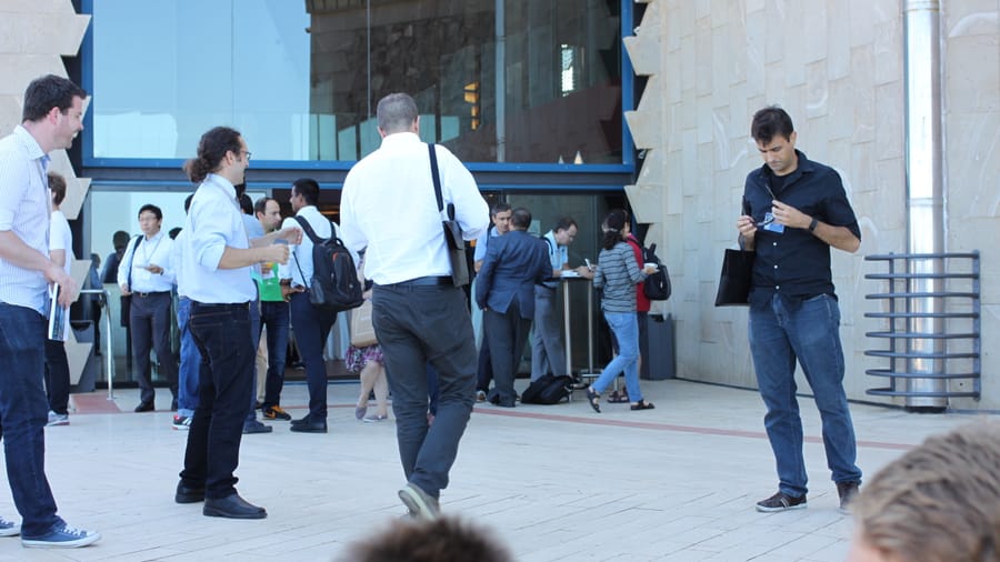 Attendees talking over coffee at a conference networking break